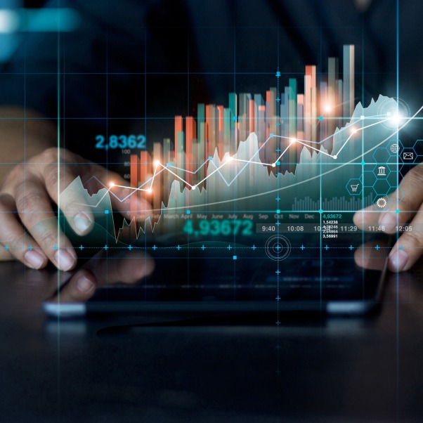 Two hands holding a holographic projection of a financial chart, displaying stock market trends and data.